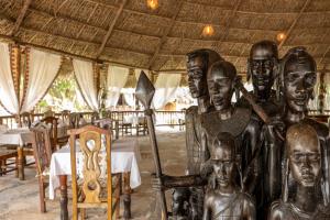 a statue of a group of people in a restaurant at Africa Safari Selous Camping in Kwangwazi +22 photos