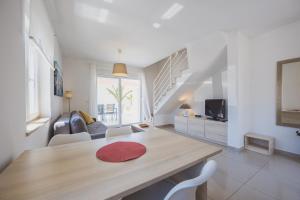 a living room with a wooden table and chairs at Luxury apartments Cuba in Novalja