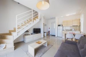 a living room with a staircase and a kitchen at Luxury apartments Cuba in Novalja
