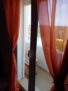 a window with a view of a bath tub at Arrifana Guest House in Aljezur