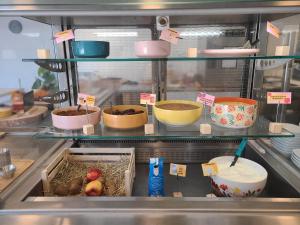 a kitchen filled with lots of bowls and food at Auberge de Jeunesse HI Cahors in Cahors