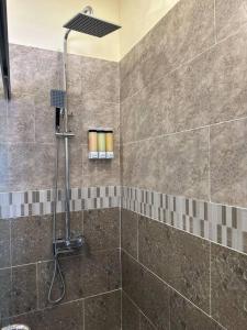 a shower with a shower head in a bathroom at Casa Bella Vista @ Pyramid Point in Ocho Rios