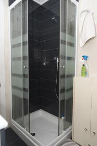 a shower with a glass door in a bathroom at Haiti, 5-15 in Cullera +8 photos
