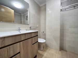 a bathroom with a sink and a toilet and a mirror at Öspede Lara Malpica de Bergantiños-Costa da Morte in Malpica +27 photos