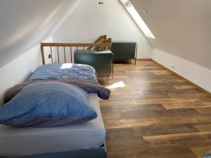 a bedroom with a bed and a wooden floor at Ferienwohnung Sanddornidylle in Graal-Müritz
