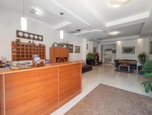 a lobby with a reception desk and a living room at Apartments Butua in Budva