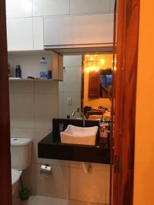 a bathroom with a sink and a toilet at Casa de praia - Trairí CE in Trairi
