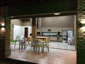 a kitchen and dining room with a table and chairs at Casa de praia - Trairí CE in Trairi