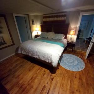 a bedroom with a large bed and a wooden floor at Funny Farm in Saint Augustine