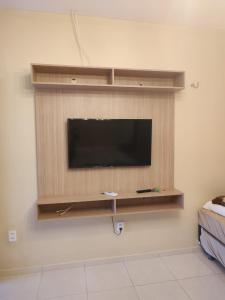 a flat screen tv on a wall in a room at Casa de praia - Trairí CE in Trairi