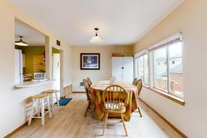 a kitchen and dining room with a table and chairs at Our Happy Place in Rockaway Beach