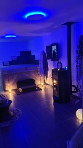 a living room with blue lights in a room at HAPPY SPA in Gouy-en-Gohelle
