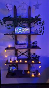 a shelf with a happy sign and lights on it at HAPPY SPA in Gouy-en-Gohelle