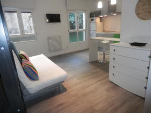 a small room with a bed and a white dresser at Bilbao céntrico 1h Zumaia in Bilbao