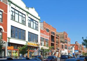 a busy city street with cars parked in front of buildings at Stay Chicago in Chicago