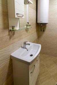 a bathroom with a sink and a mirror at D'arte Apart in Balchik