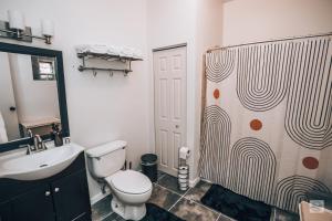 a bathroom with a toilet and a sink and a shower at Studio 424 in Chicago