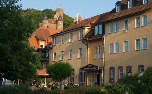 a group of buildings with a castle in the background at Hotel Bronnbacher Hof in Wertheim