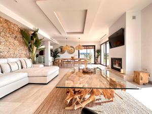 uma sala de estar com um sofá branco e uma mesa de vidro em Villa Cas Hespero em San Antonio