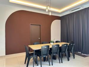 a conference room with a wooden table and chairs at [OFFICIAL] Desaru Villa Resort @ Arcadia in Desaru