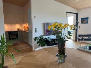 a living room with a vase of flowers on a table at Atlantic Jewel in Tórshavn