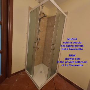 a shower stall with a glass door in a bathroom at La Tavernetta in Torre Pellice