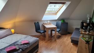 a bedroom with a bed and a table and chairs at Strand4-Quartier Ferienwohnungen Ostseebad Karlshagen in Ostseebad Karlshagen