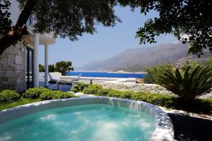 a swimming pool with a view of the ocean at Alley Prime Hotel in Kaş