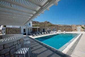 a villa with a swimming pool and a patio at Villa Orion Mykonos - Magnificent Sea View in Mikonos
