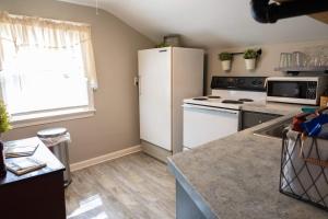 a kitchen with a white refrigerator and a stove at The Carriage House 1836 in Millersburg