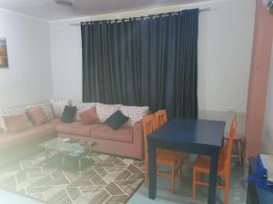 a living room with a couch and a table at Abeer Suites 3 basement in Hurghada +22 photos