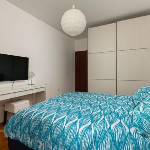 a bedroom with a bed and a desk and a television at Panoramic Bliss in Herceg Novi in Herceg-Novi