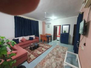a living room with a red couch and a table at Abeer Suites 3 basement in Hurghada