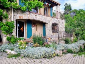 a stone house with a garden in front of it at La maison de Ninia in Digne-les-Bains
