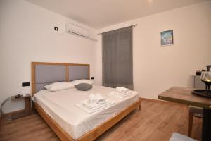 a bedroom with a bed with towels on it at VILA PERLA in Trebinje
