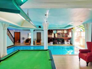 an indoor pool with a pool table in a house at The Park Pool Villa Pattaya in Pattaya Central