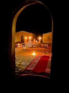 a view of a bed in a desert at night at Desert Erg Chegaga Camp in El Gouera