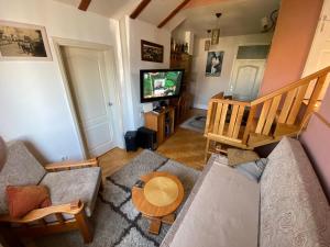 a living room with a couch and a television at Markus Apartment in Kragujevac