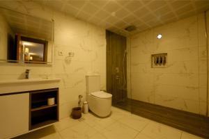 a bathroom with a toilet and a sink and a shower at Varyant Hotel in Konak