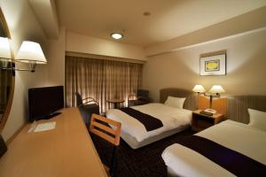 Postel nebo postele na pokoji v ubytování Canal City Fukuoka Washington Hotel