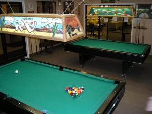 two pool tables in a room with sidx sidx sidxangering at Preferred RV Resort in Pahrump