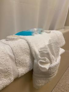 a white towel with a toothbrush on top of it at Gold Coast Family Cottages in Oscoda