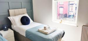 1 dormitorio con cama con almohada y ventana en Gilpin House, en Leeds