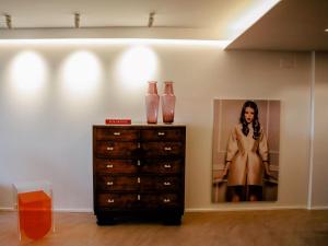 a dresser with two vases and a picture of a woman at Loft Sotos de la Albolafia in Córdoba