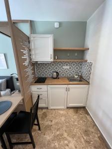 A kitchen or kitchenette at Mageiras Boutique Hotel