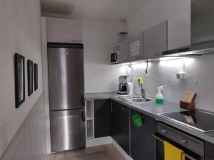 a small kitchen with a stainless steel refrigerator at PoppaLiving Oy II in Vaasa
