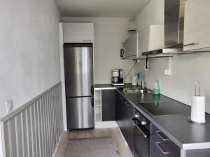 a kitchen with a large stainless steel refrigerator at PoppaLiving Oy II in Vaasa