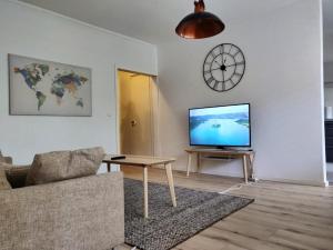 a living room with a couch and a tv at PoppaLiving Oy II in Vaasa