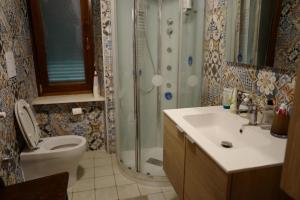 a bathroom with a shower and a toilet and a sink at Villa di Piera in Montieri +91 photos