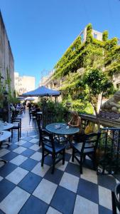 a woman sitting at a table on a patio at Mi corazon en San Telmo in Buenos Aires